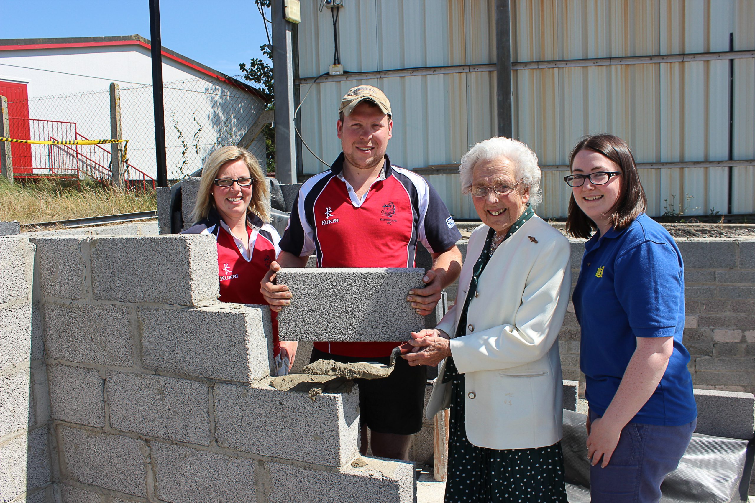 Mrs Mary Trimble MBE lays a brick at the new Rathfriland YFC hall on Downpatrick Street assisted by club leader Christopher Simpson as Club President Rosemary McConnell and Vice President Rebecca McConnell look on.
